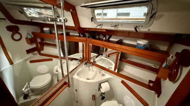 Elan Yacht Photos Pics 1989 J Boats J/40 yacht bathroom with wooden accents and compact design.