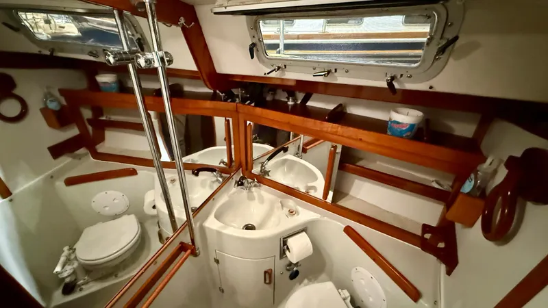 Elan Yacht Photos Pics 1989 J Boats J/40 yacht bathroom with wooden accents and nautical decor.