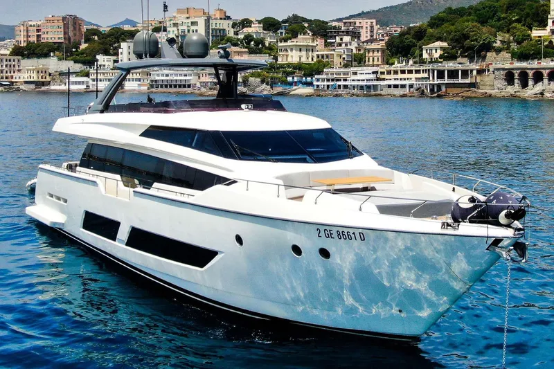 E3 Yacht Photos Pics 2019 Ferretti Yachts 850 cruising near a scenic coastal town.