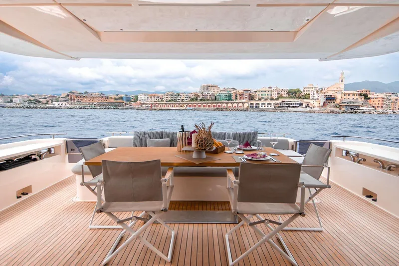 E3 Yacht Photos Pics Luxurious 2019 Ferretti Yachts 850 with elegant dining area overlooking scenic coastal view.