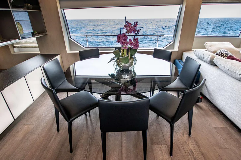 E3 Yacht Photos Pics Luxurious interior of 2019 Ferretti Yachts 850 with ocean view and elegant dining area.