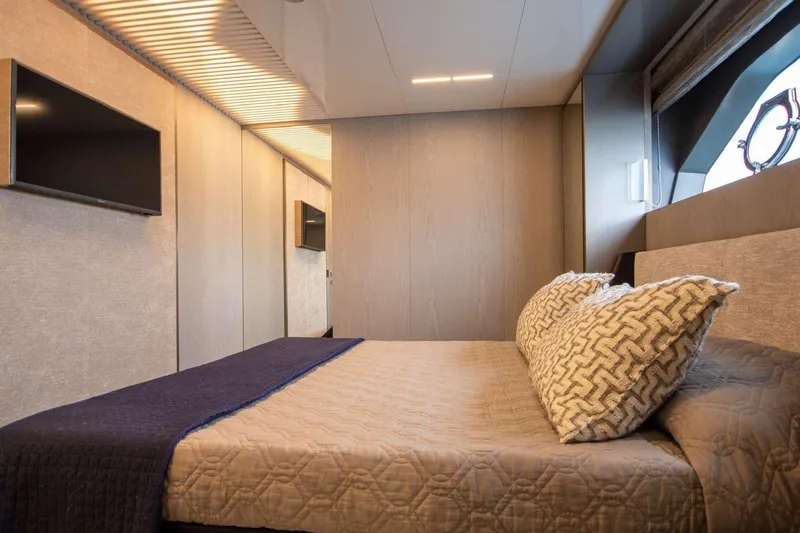 E3 Yacht Photos Pics Luxurious bedroom interior of 2019 Ferretti Yachts 850 with modern design and cozy bedding.