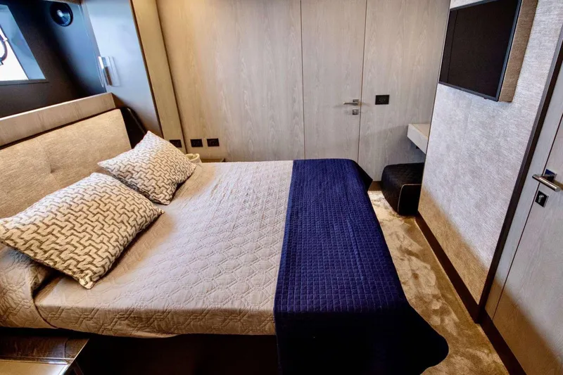 E3 Yacht Photos Pics Luxurious bedroom interior of 2019 Ferretti Yachts 850 with modern decor and cozy bedding.