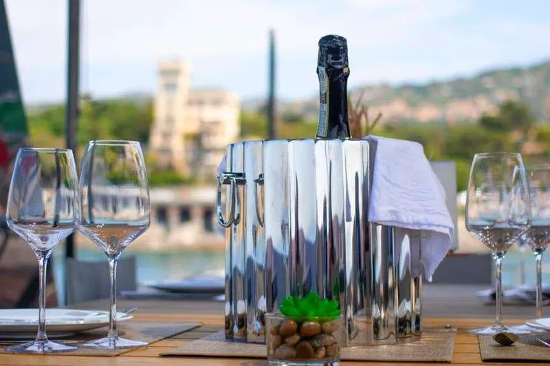 E3 Yacht Photos Pics Luxury dining setup on 2019 Ferretti Yachts 850, featuring wine glasses and a bottle in an ice bucket.