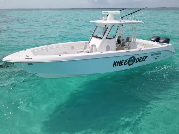 Knee Deep Yacht Photos Pics 2015 Everglades 325 Center Console boat on clear turquoise water.