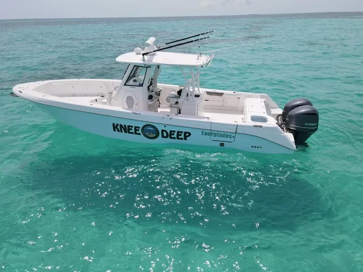 Knee Deep Yacht Photos Pics 2015 Everglades 325 Center Console boat on clear turquoise water.