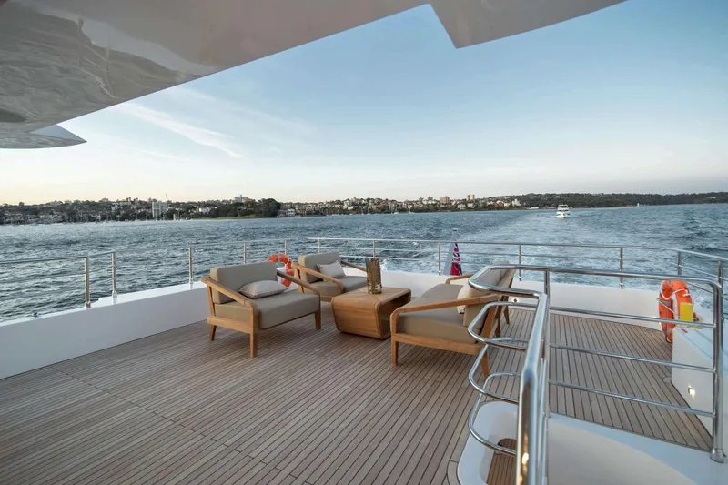  Yacht Photos Pics Luxurious Nomad 101 yacht deck with elegant seating, overlooking serene waters, 2026 model.