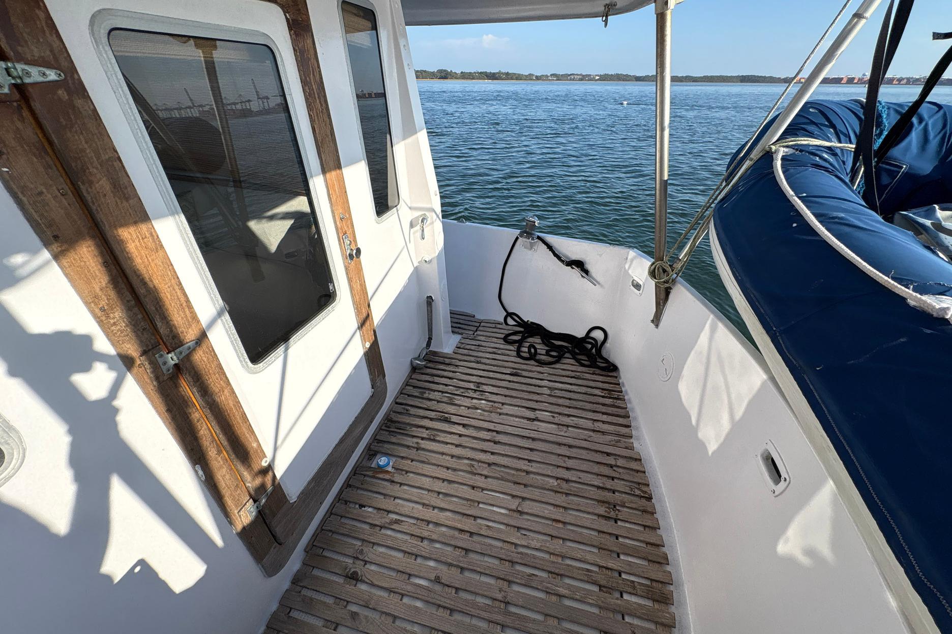 1979 Schucker 436 Motorsailor deck with wooden accents and ocean view.