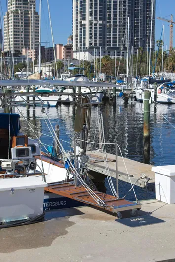 Aries Yacht Photos Pics 1982 Sea Star 46 docked at marina with city skyline in background.