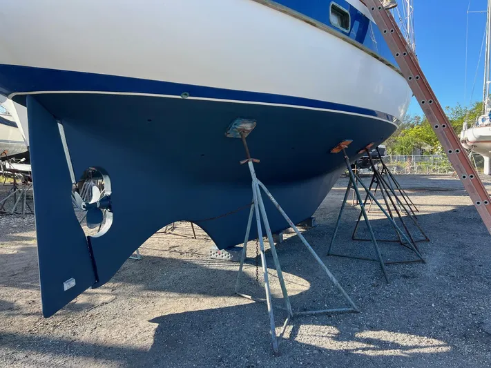 Aries Yacht Photos Pics 1982 Sea Star 46 sailboat on stands, hull view, in a boatyard.
