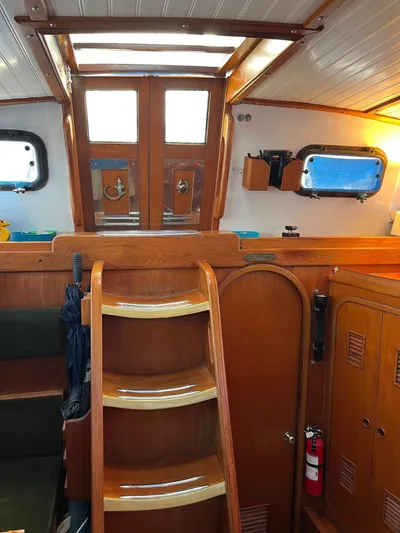 Aries Yacht Photos Pics Interior of 1982 Sea Star 46 sailboat with wooden stairs and nautical decor.