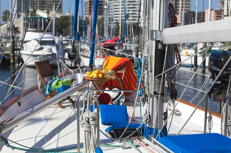 Aries Yacht Photos Pics Sailboat deck with colorful towels and fruit, Sea Star 46, 1982 model, docked in marina.