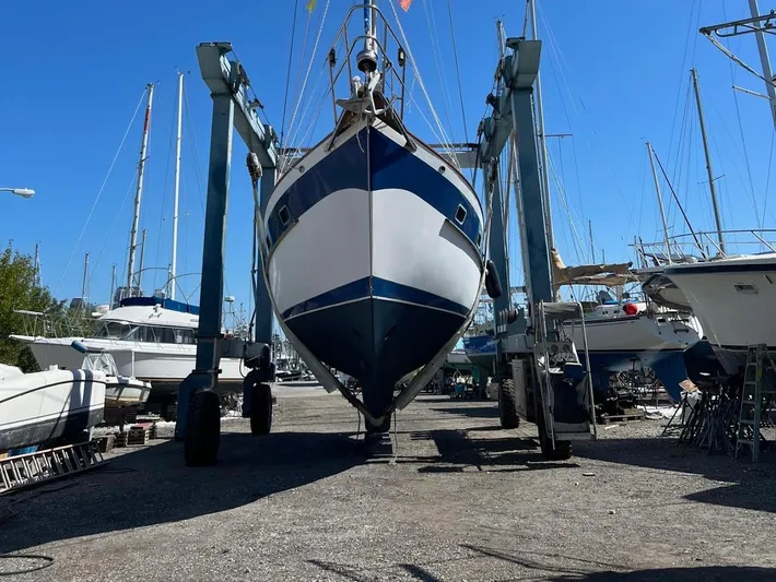 Aries Yacht Photos Pics 1982 Sea Star 46 sailboat in dry dock, surrounded by other boats under clear blue sky.