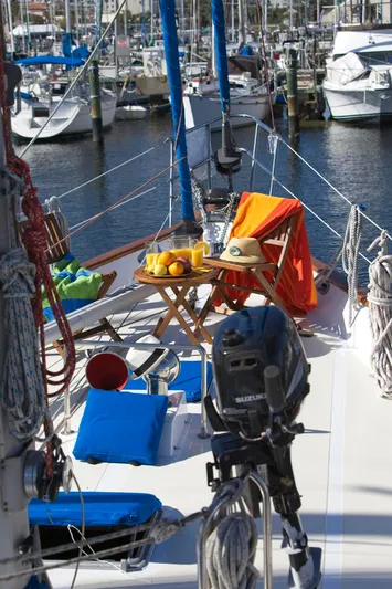 Aries Yacht Photos Pics 1982 Sea Star 46 sailboat with deck seating, fruit, and marina backdrop.