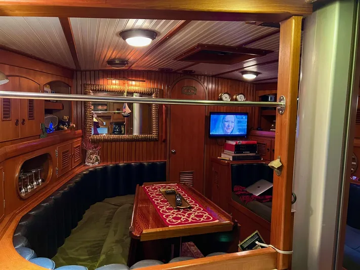 Aries Yacht Photos Pics Luxurious 1982 Sea Star 46 yacht interior with wood paneling and cozy seating area.