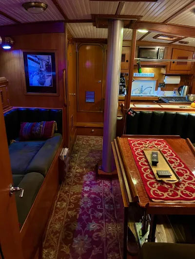 Aries Yacht Photos Pics Cozy interior of 1982 Sea Star 46 yacht with wood paneling and elegant dining area.