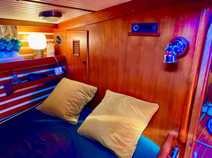 Aries Yacht Photos Pics Cozy cabin interior of 1982 Sea Star 46 yacht with wooden paneling and soft lighting.