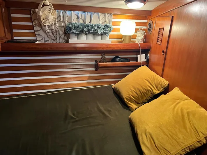 Aries Yacht Photos Pics Cozy cabin interior of 1982 Sea Star 46 yacht with wooden paneling and soft lighting.