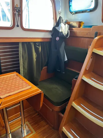 Aries Yacht Photos Pics Interior of 1982 Sea Star 46 boat with wooden stairs and seating area.