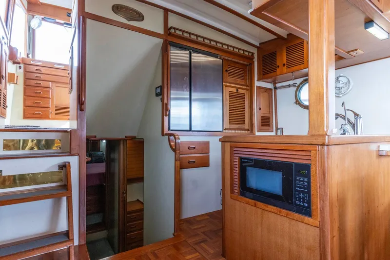 Points North III Yacht Photos Pics Interior of 1986 Kadey-Krogen 42 yacht with wooden cabinetry and built-in microwave.