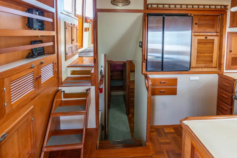 Points North III Yacht Photos Pics Interior of 1986 Kadey-Krogen 42 yacht with wooden cabinetry and stairs.