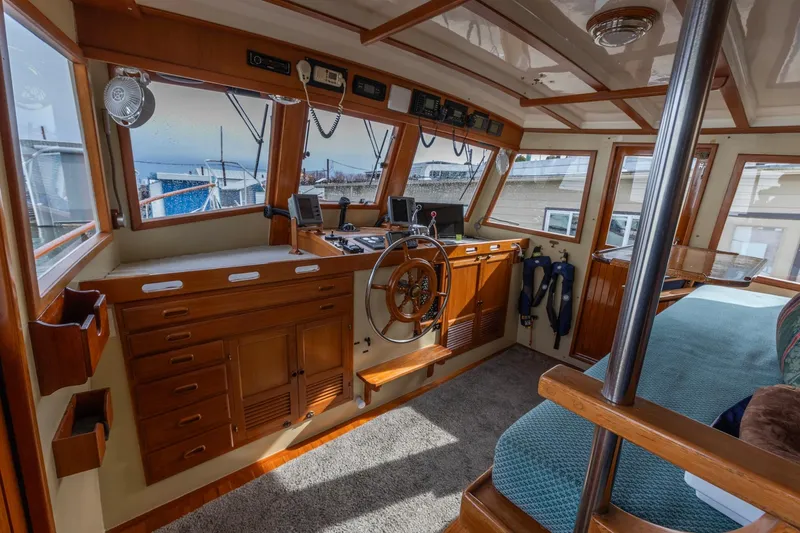 Points North III Yacht Photos Pics Interior of 1986 Kadey-Krogen 42 boat with wooden helm and navigation equipment.
