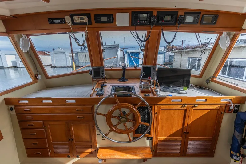 Points North III Yacht Photos Pics 1986 Kadey-Krogen 42 boat helm with wooden cabinetry and navigation equipment.