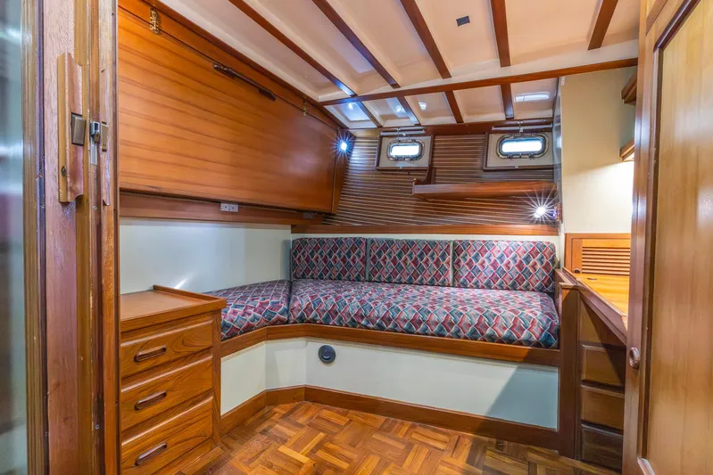 Points North III Yacht Photos Pics Cozy cabin interior of 1986 Kadey-Krogen 42 yacht with wood finish and patterned seating.