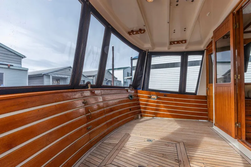 Points North III Yacht Photos Pics Enclosed deck of 1986 Kadey-Krogen 42 yacht with wooden paneling and large windows.