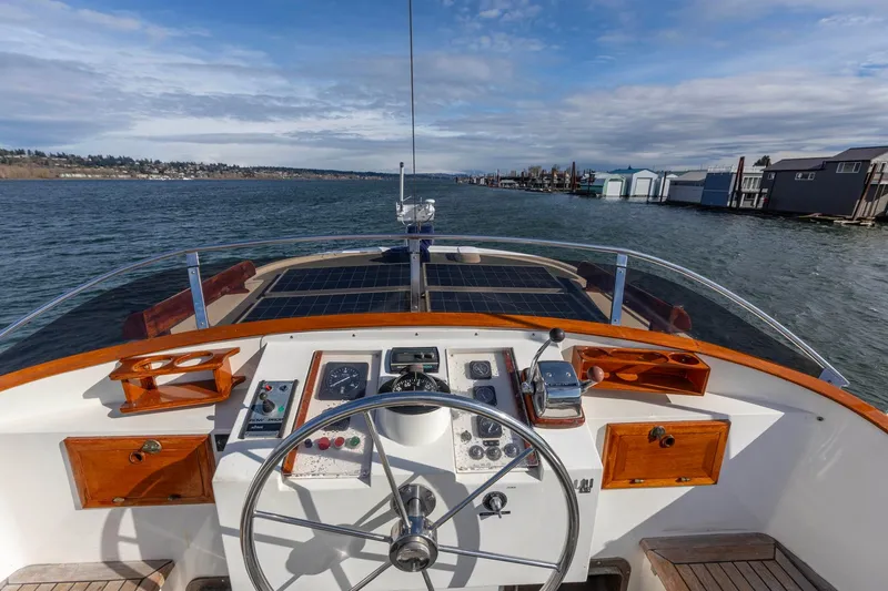 Points North III Yacht Photos Pics Helm of 1986 Kadey-Krogen 42 yacht with scenic waterway view.