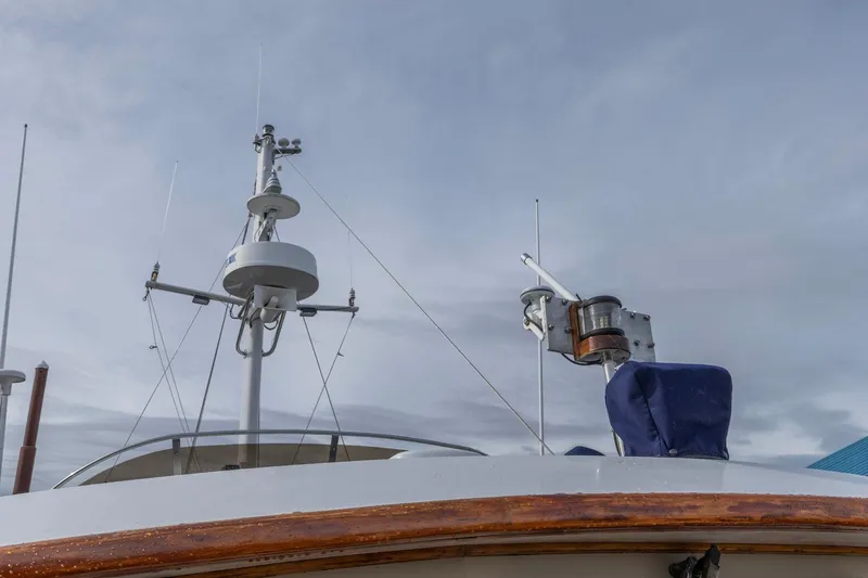 Points North III Yacht Photos Pics 1986 Kadey-Krogen 42 boat mast and radar equipment against cloudy sky.