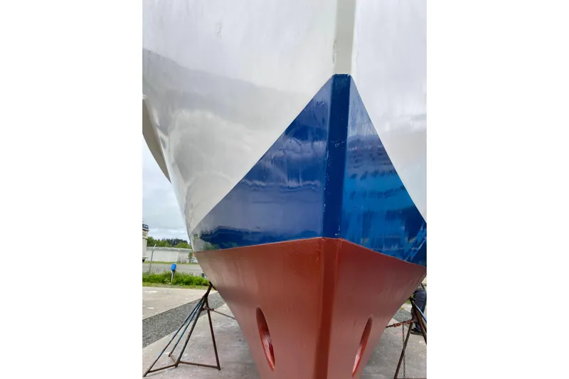 Points North III Yacht Photos Pics 1986 Kadey-Krogen 42 boat hull with blue and red paint, on stands.