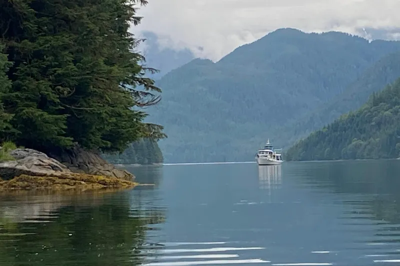 Points North III Yacht Photos Pics 1986 Kadey-Krogen 42 yacht cruising in serene, forested mountain landscape.