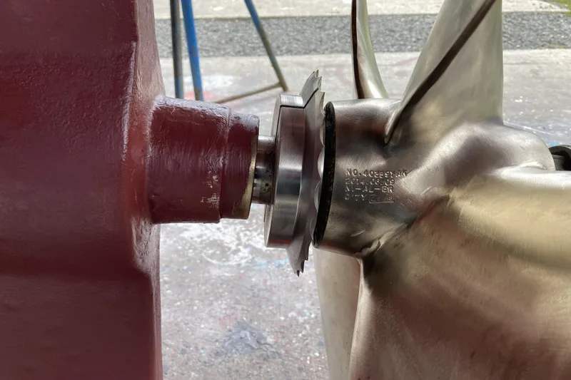 Points North III Yacht Photos Pics Close-up of a 1986 Kadey-Krogen 42 propeller and shaft assembly in a workshop.