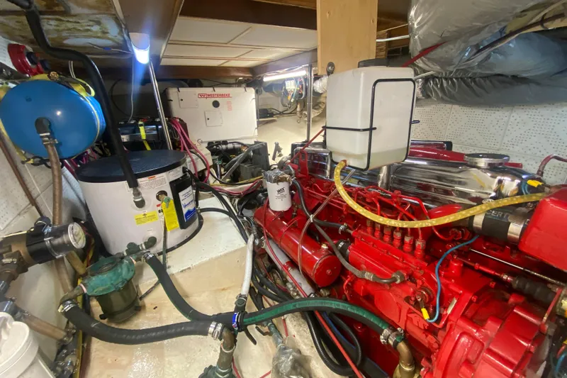 Points North III Yacht Photos Pics Engine room of a 1986 Kadey-Krogen 42 yacht, featuring a red engine and various components.