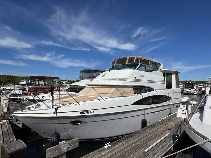  Yacht Photos Pics 2002 Carver 466 Motor Yacht docked at marina under clear blue sky.