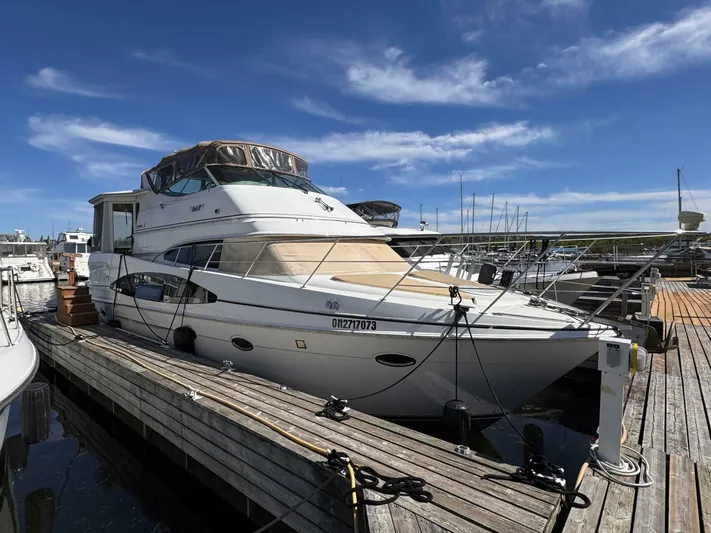  Yacht Photos Pics 2002 Carver 466 Motor Yacht docked at marina under clear blue sky.
