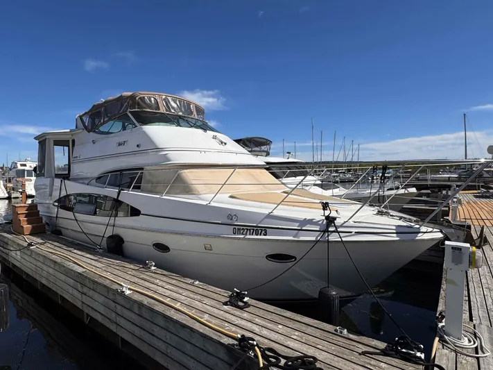  Yacht Photos Pics 2002 Carver 466 Motor Yacht docked at marina under clear blue sky.