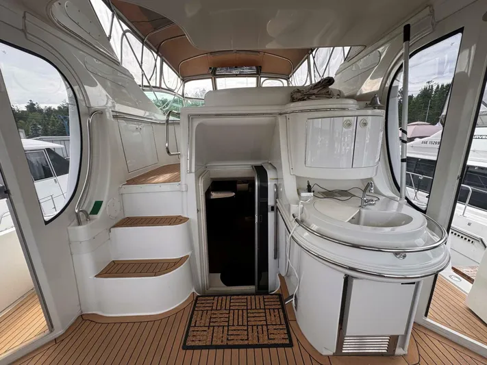  Yacht Photos Pics 2002 Carver 466 Motor Yacht interior with stairs, sink, and wooden flooring.