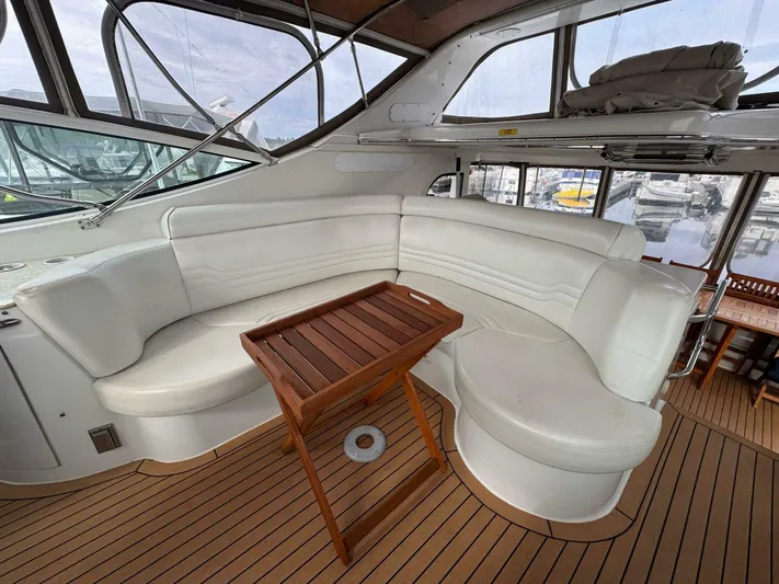  Yacht Photos Pics Luxurious interior of 2002 Carver 466 Motor Yacht with white seating and wooden table.