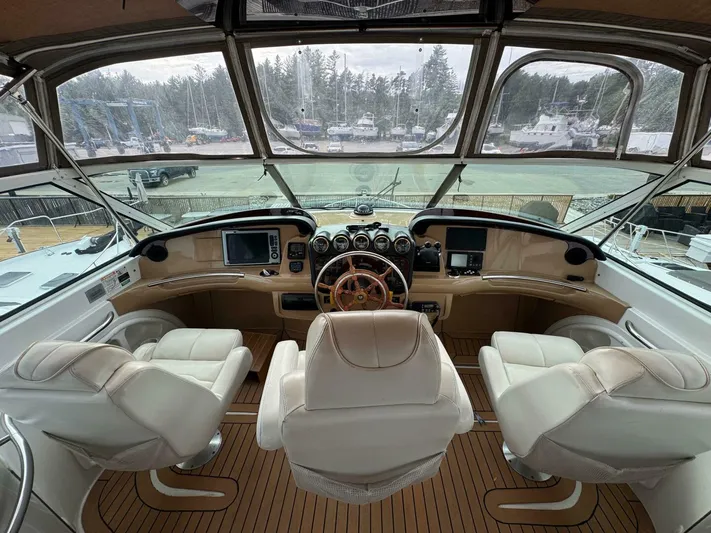  Yacht Photos Pics Interior view of 2002 Carver 466 Motor Yacht helm with leather seats and navigation controls.