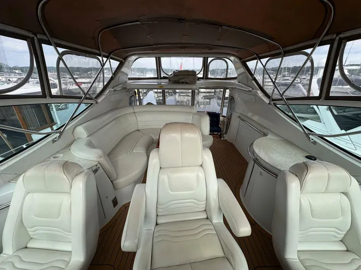  Yacht Photos Pics 2002 Carver 466 Motor Yacht interior with white leather seating and panoramic windows.