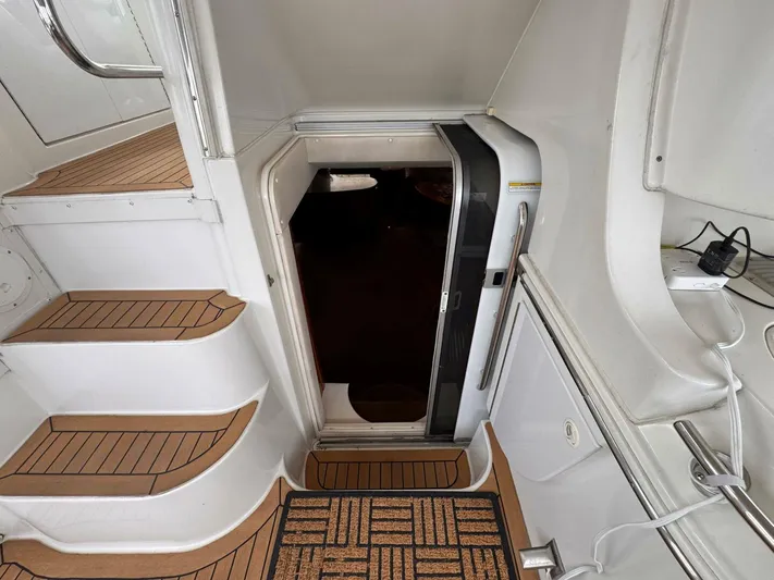 Yacht Photos Pics 2002 Carver 466 Motor Yacht interior entrance with wooden steps and open door.