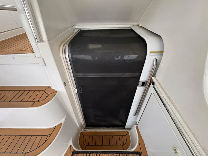  Yacht Photos Pics 2002 Carver 466 Motor Yacht entrance with wooden steps and screen door.