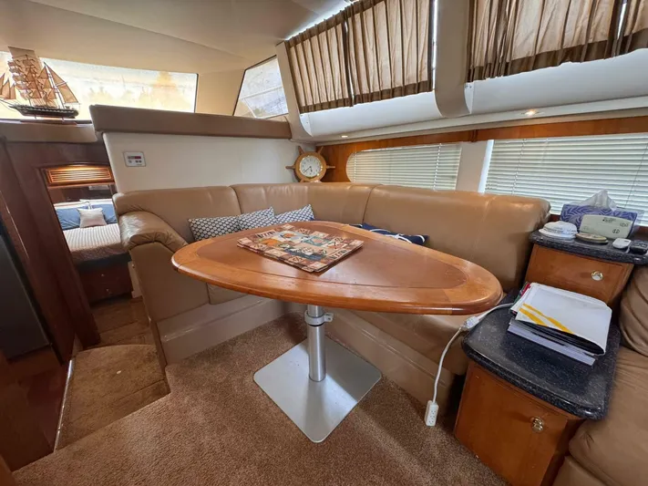  Yacht Photos Pics Interior of 2002 Carver 466 Motor Yacht with leather seating and wooden table.