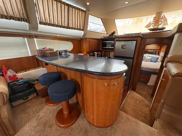  Yacht Photos Pics Interior of 2002 Carver 466 Motor Yacht with kitchen and seating area.