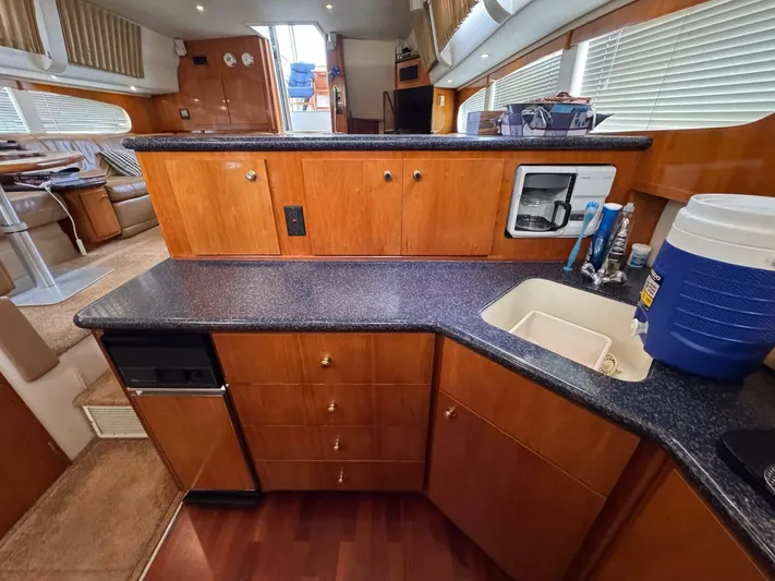  Yacht Photos Pics Interior of 2002 Carver 466 Motor Yacht kitchen with wood cabinetry and appliances.