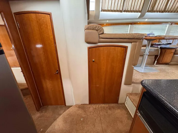  Yacht Photos Pics Interior of 2002 Carver 466 Motor Yacht with wooden doors and plush seating.