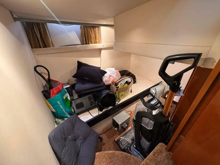  Yacht Photos Pics 2002 Carver 466 Motor Yacht interior with storage items and equipment.