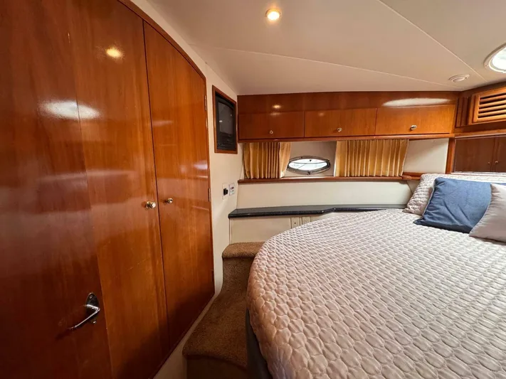  Yacht Photos Pics Interior of 2002 Carver 466 Motor Yacht with cozy bedroom and wooden cabinetry.